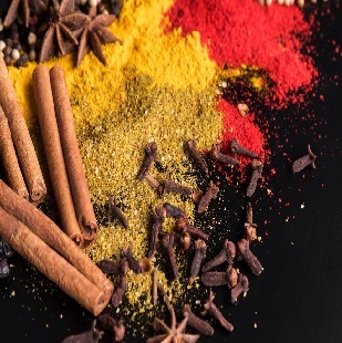 Variety of spices against dark backdrop.